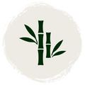 A minimalist bamboo icon featuring dark green bamboo stalks and leaves centered within a circular, textured off-white background on a solid white canvas.